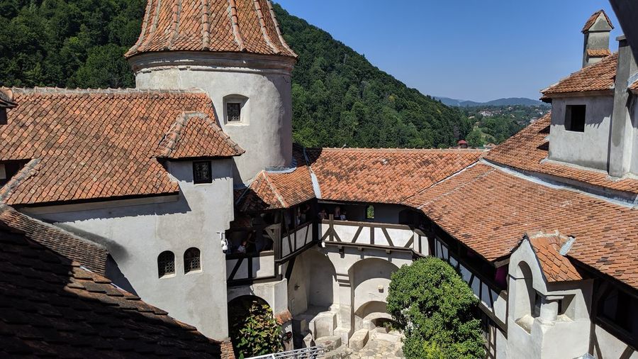 Exterior of houses by buildings against sky