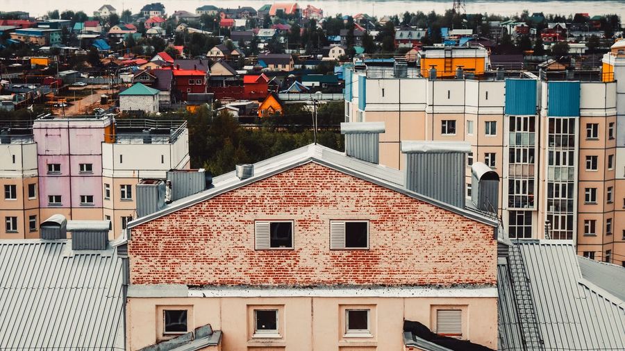 Houses in town against sky