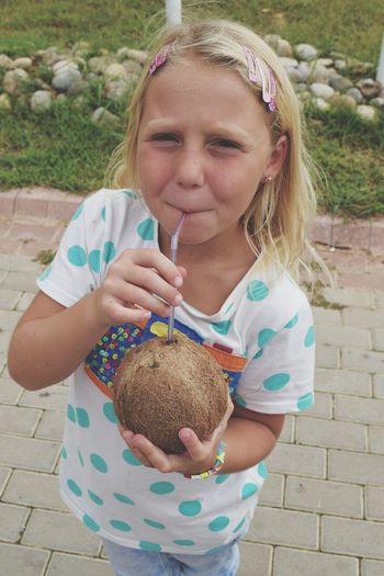 Close-up portrait of girl drinking coconut water