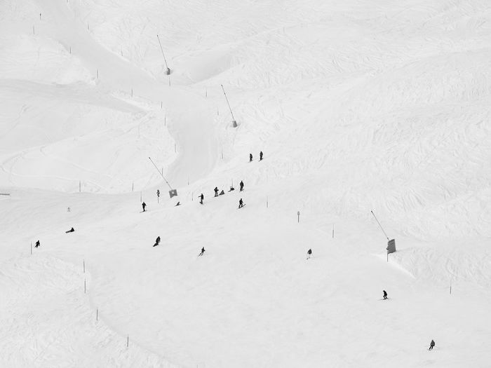 High angle view of people skiing on snow covered land