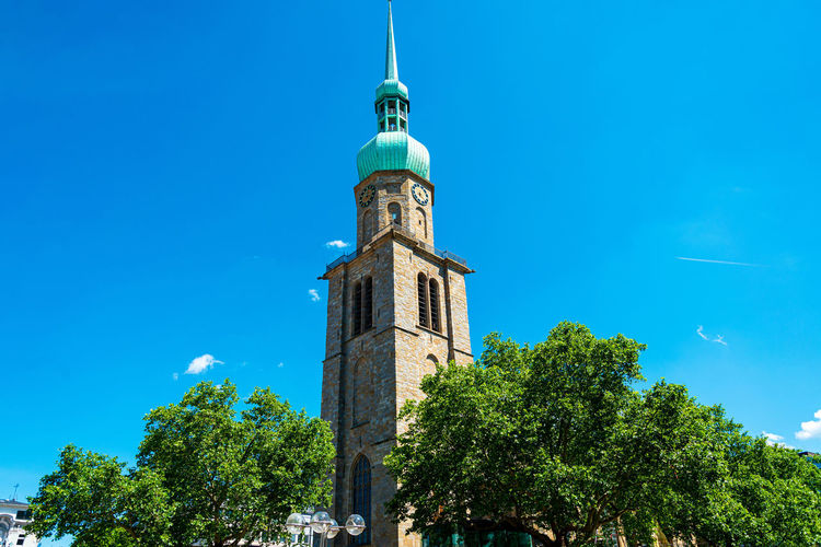 Low angle view of building against clear blue sky