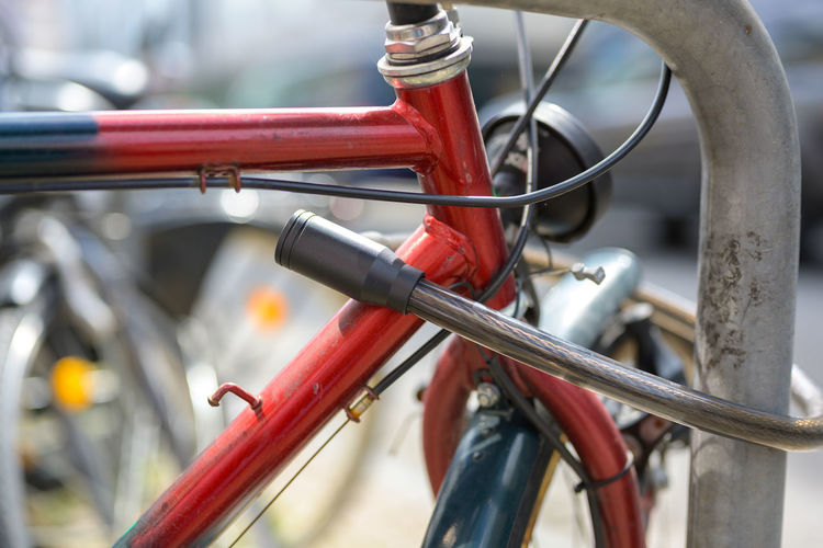 Close-up of bicycle parked by railing