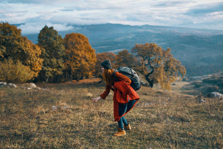 Side view of woman walking on mountain