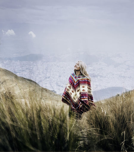 Women standing on field against sky