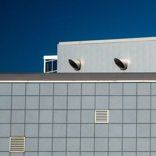 Low angle view of airport building against clear sky