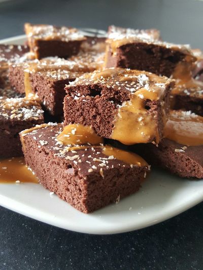 Close-up of coconut and caramels on chocolate cake served in plate
