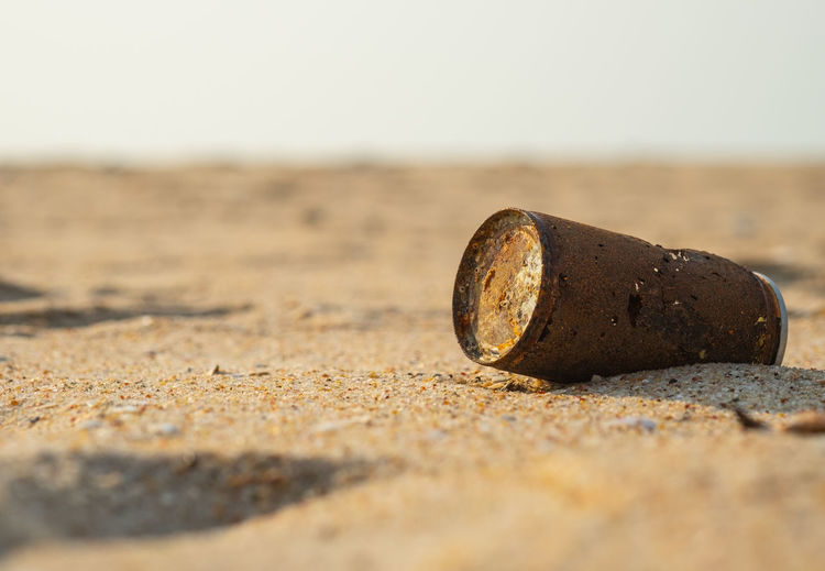 Close-up of rusty metal on beach