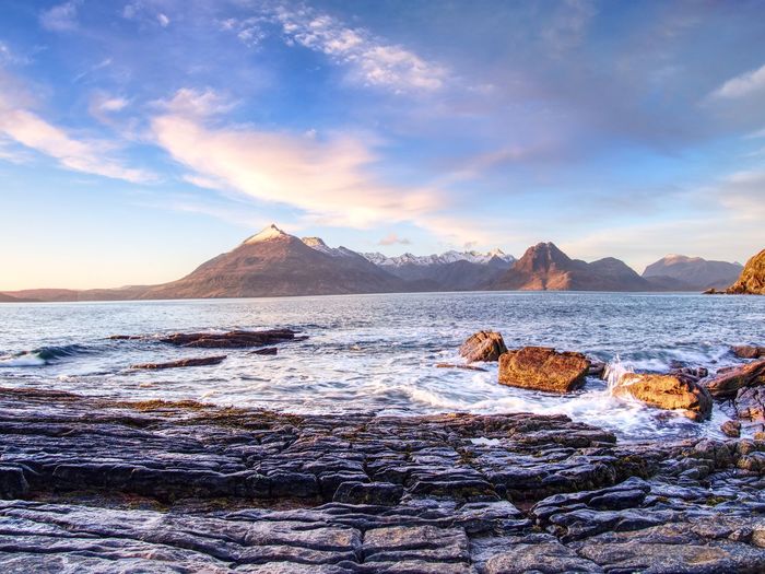 Peaceful dawn at elgol bay. overlooking of shore rocks and smooth sea. winter isle of skye, scotland