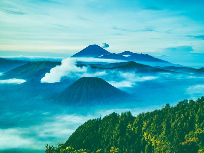 Scenic view of mountains against cloudy sky