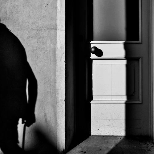 Shadow of person on door of building