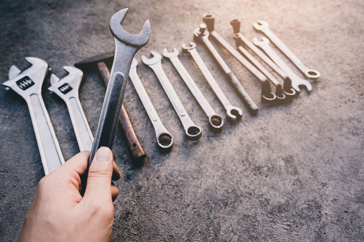 High angle view of hand holding tools