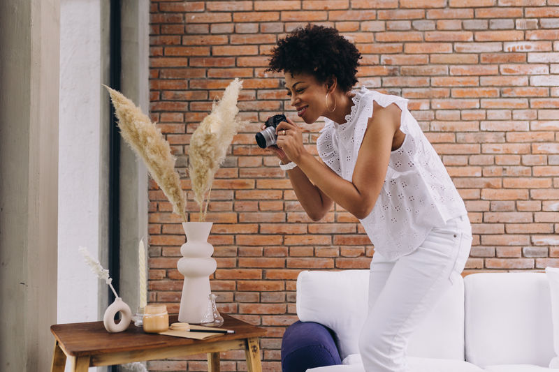 Black woman photographer creating content indoors
