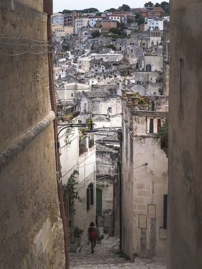 High angle view of people walking on alley amidst building in matera, italy.