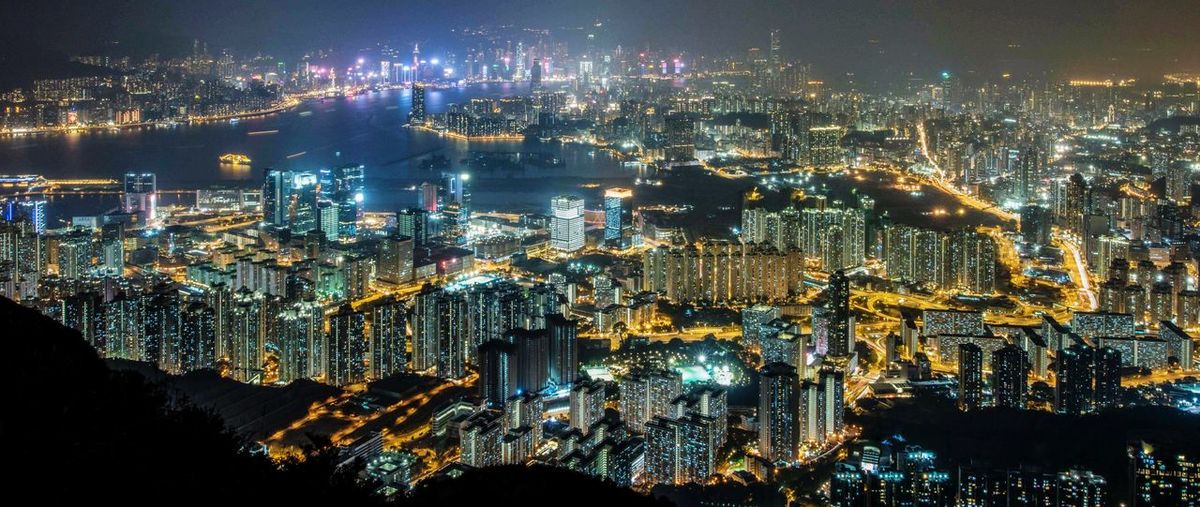 High angle view of city lit up at night