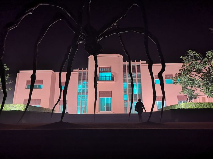 Illuminated building against sky at night