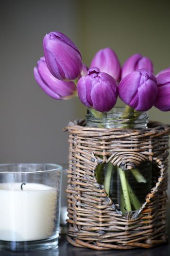 Close-up of pink flower in glass container on table