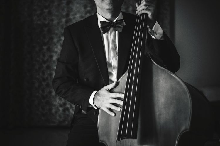 Full length of man playing double bass