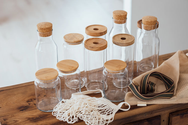 Zero waste concept. textile eco-bags and empty glass jars on a wooden table.