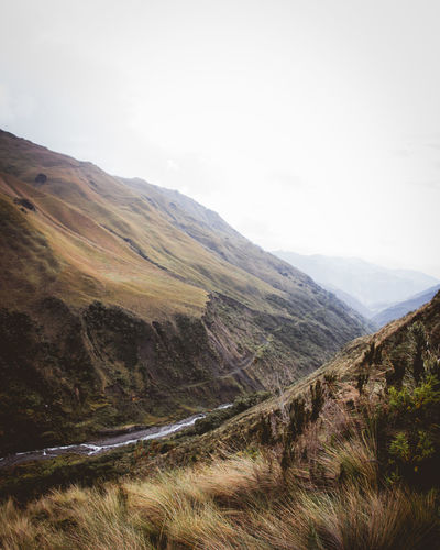 Scenic view of mountains against sky with moody tones 