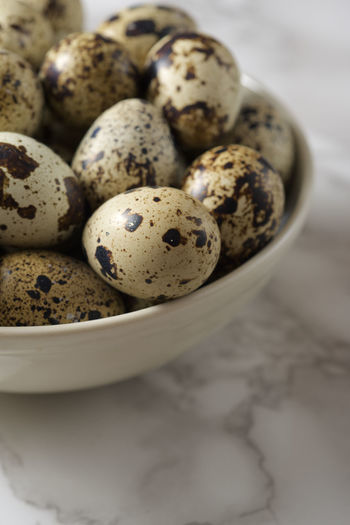 Quail eggs on a marble table.