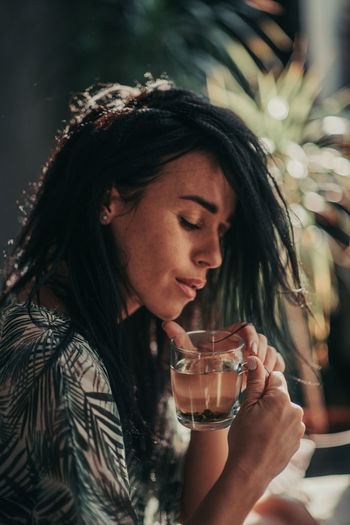 Close-up of woman drinking glass