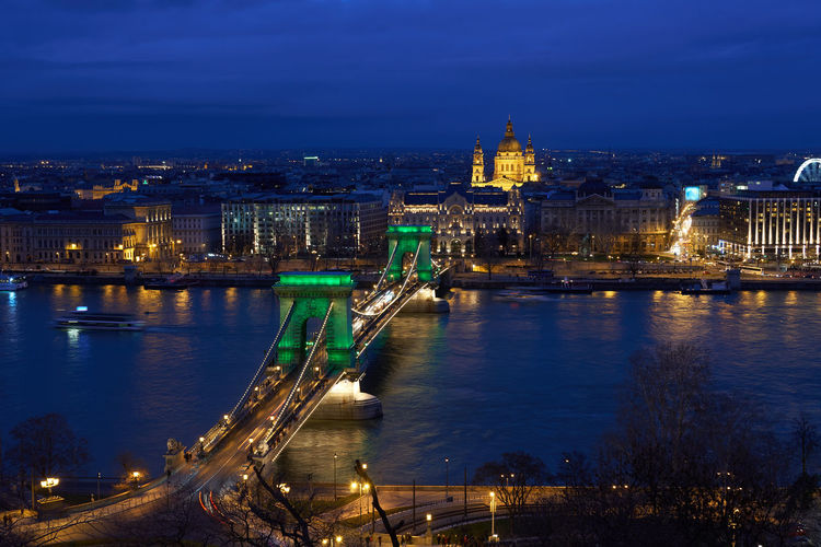 Budapest nighttime cityscape with chain bridge illuminated in green