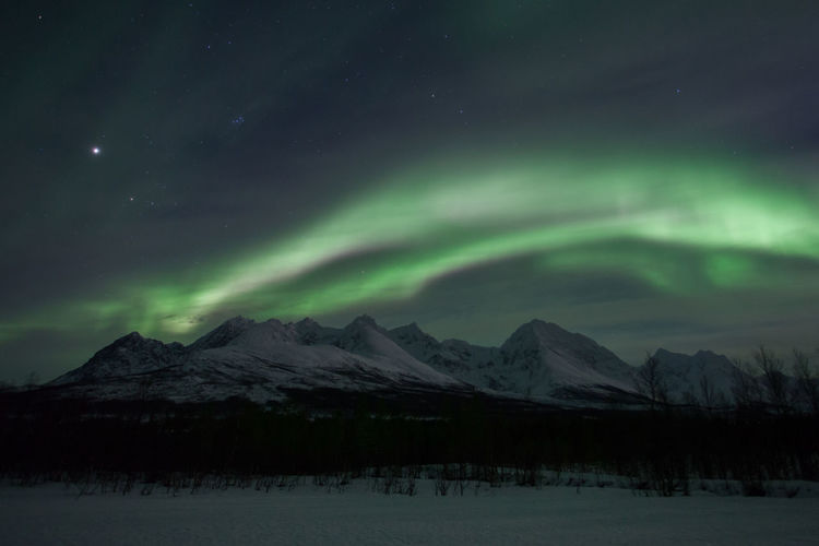 Scenic view of aurora borealis over lyngen alps