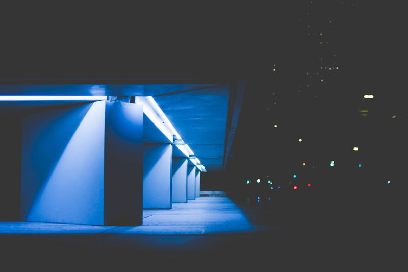 Illuminated corridor of building at night