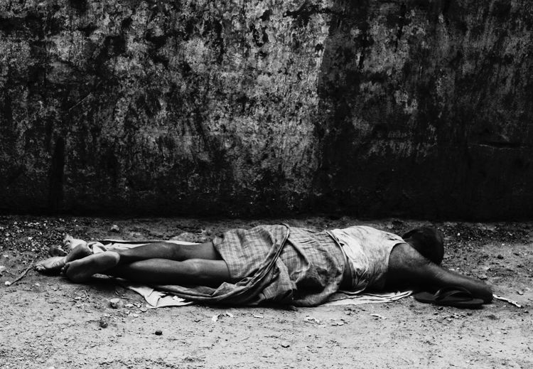 Beggar sleeping on street
