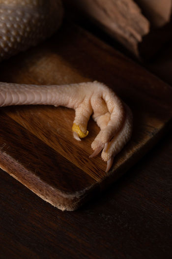 High angle view of hand on cutting board