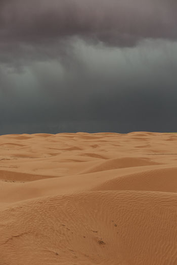 Sand dunes under stormy rain clouds in the desert of canyonlands utah