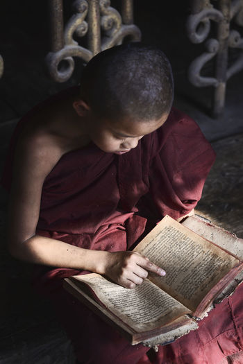 Monk reading book at temple