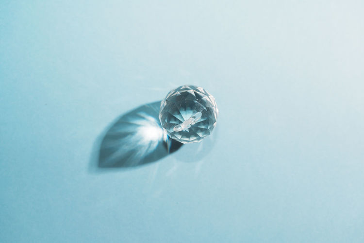 Close-up of crystal against blue background