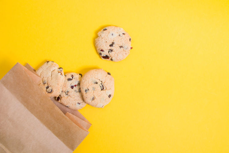 High angle view of cookies against yellow background