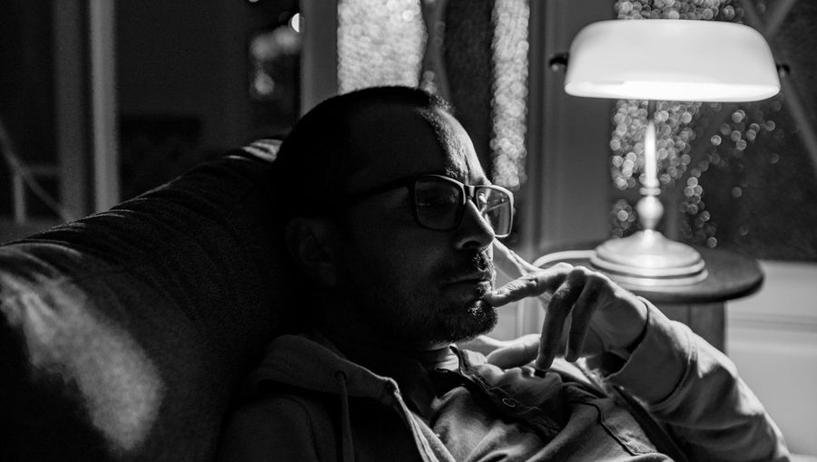 Portrait of young man looking away at home