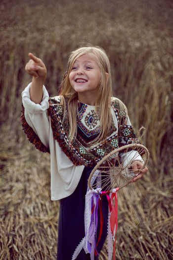 Girl indian shaman blonde in a poncho and a dream catcher