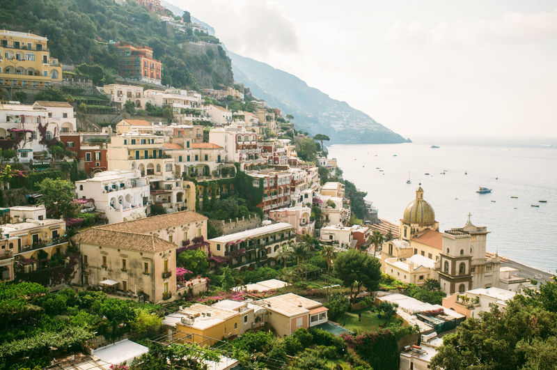 Buildings on mountains by sea at positano