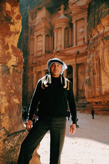Portrait of mature man standing at historical building at petra