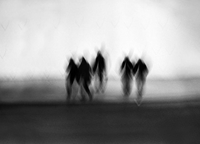 Defocused image of people walking against blurred background