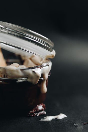 Close-up of ice cream in glass jar on table