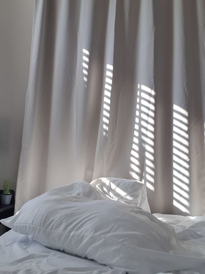 White curtain on bed at home