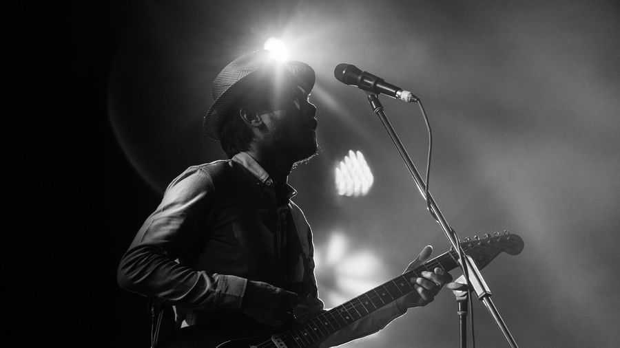 Low angle view of singer with guitar during music concert