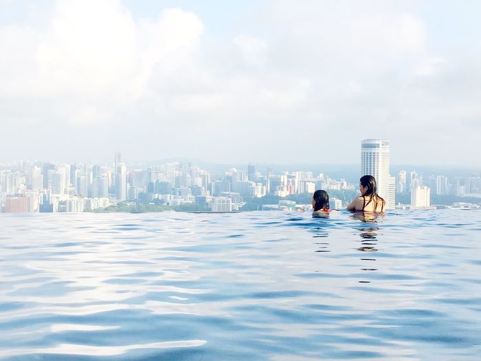 Women looking at view from infinity pool at marina bay sands