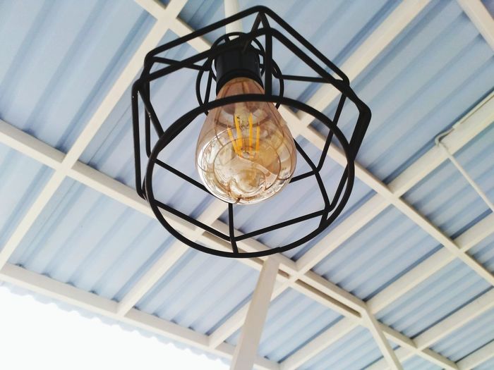 Low angle view of pendant light hanging from ceiling