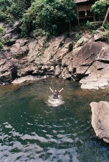 High angle view of man on rock by river