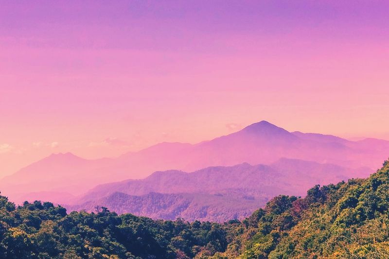 Scenic view of mountains against sky at dusk