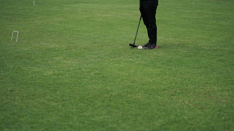 Low section of person standing on field
