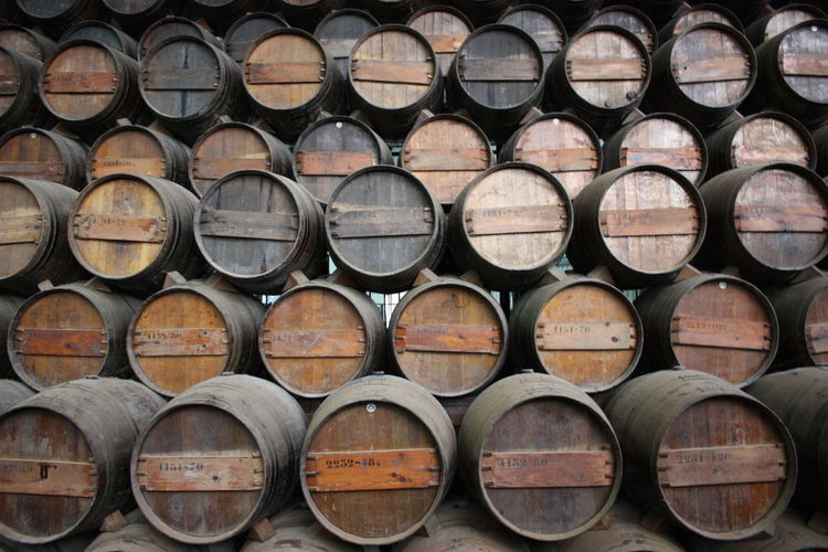Full frame shot of stacked wine casks in warehouse