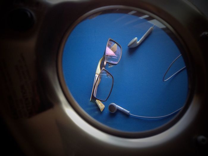 Eyeglasses and headphones seen through glass