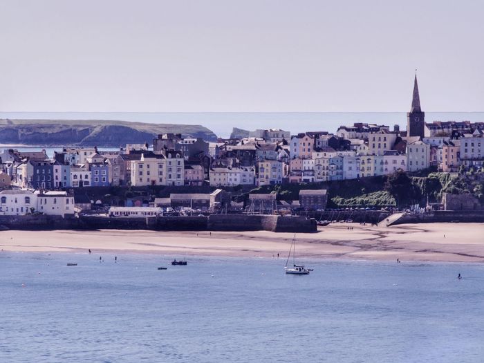 Coastal town and harbour of tenby, south wales, uk. view from coast to coast path.